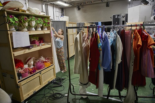 Costumes lined up and ready for the cast in the backstage area