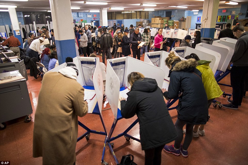 3A2C58CA00000578-3914992-High_turnouts_Voters_fill_out_their_forms_and_wait_to_vote_at_a_-a-176_1478610899235